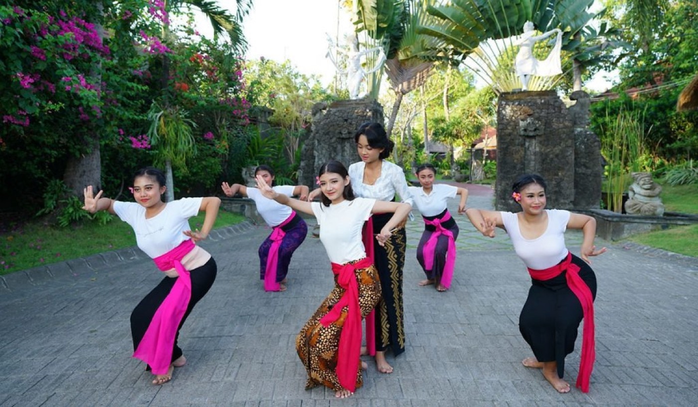 Students learning Balinese dance in a garden