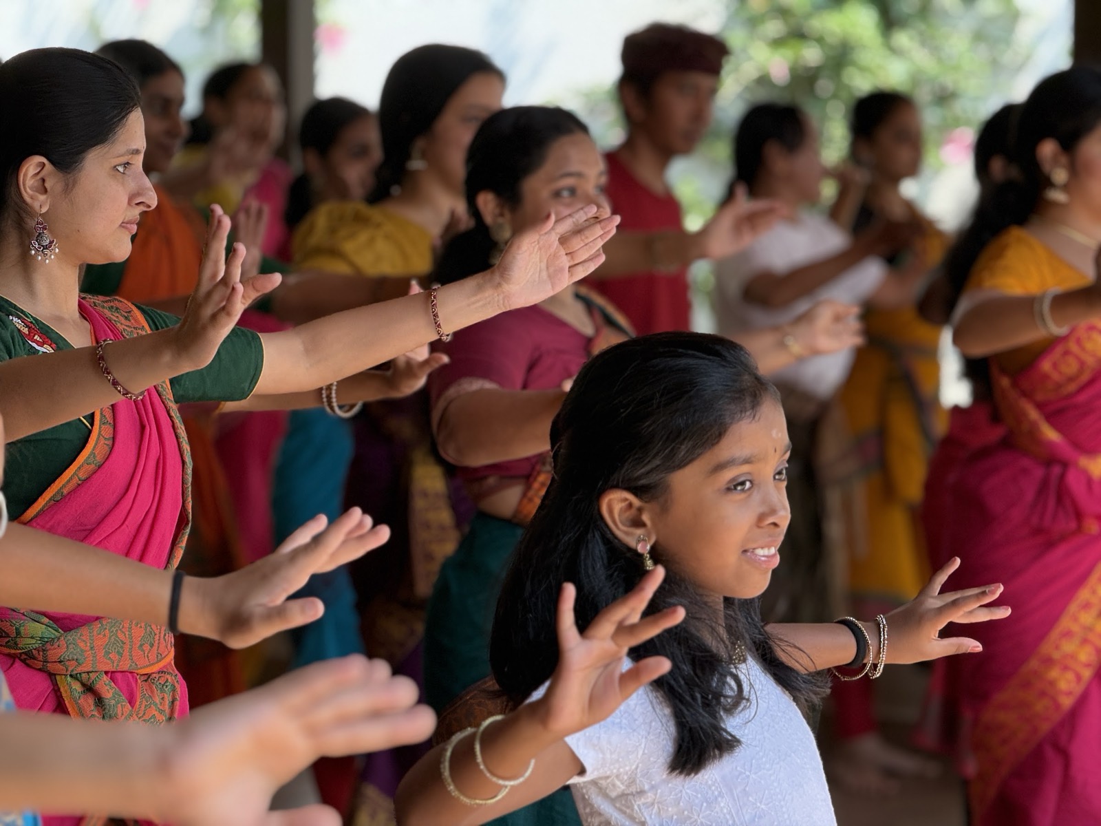 Participants learning Balinese dance movement in a workshop