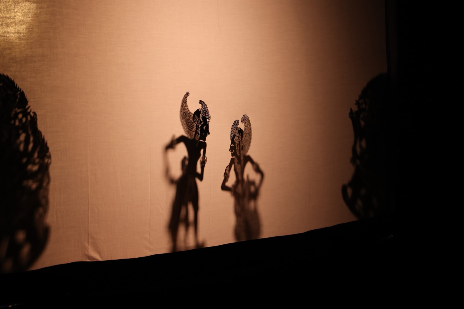 Balinese shadow puppets cast on the screen