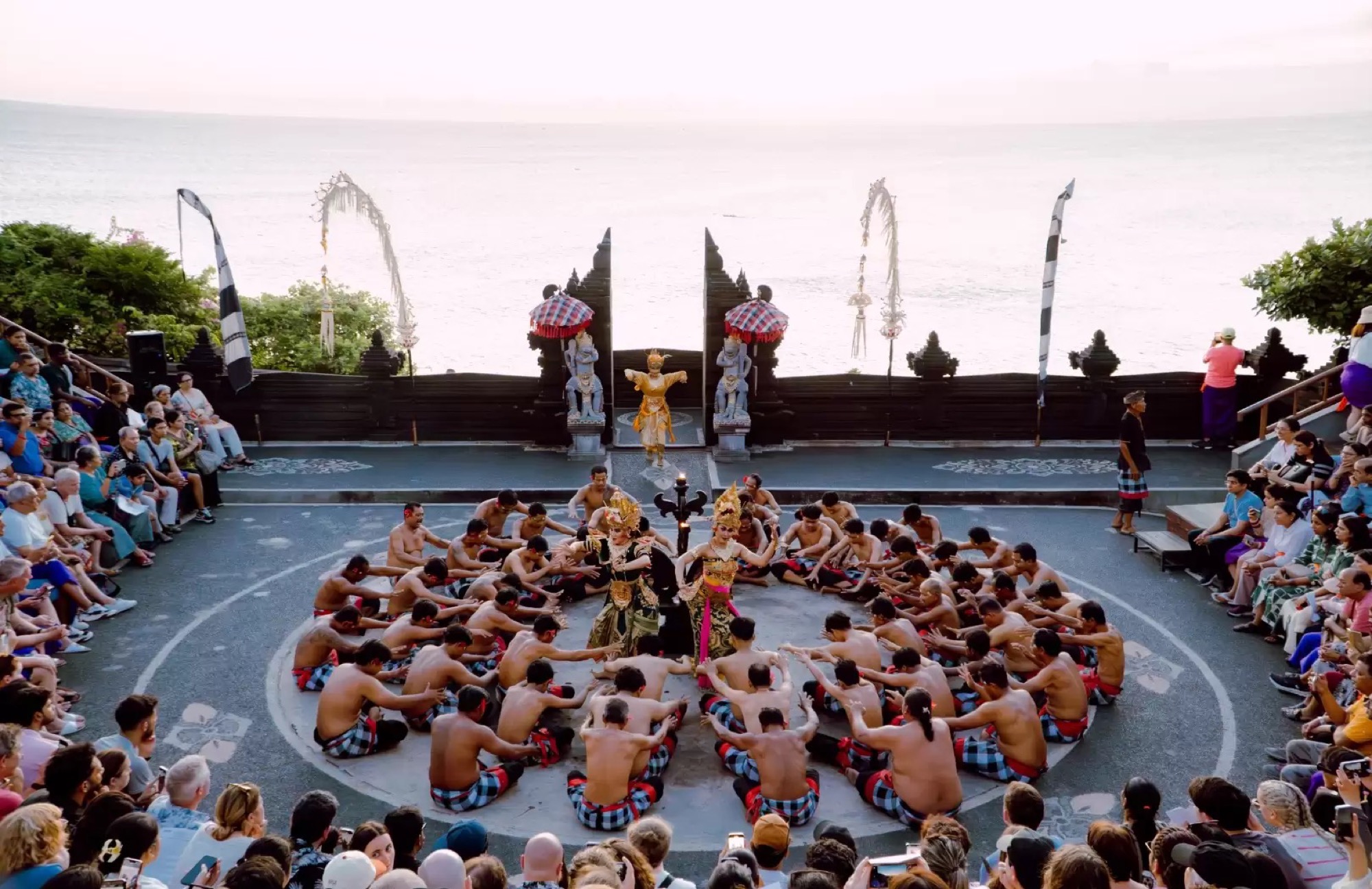 Kecak performance in a circle beside the sea at sunset in Bali